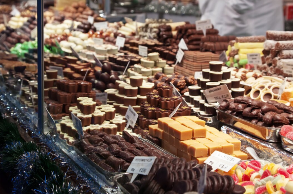 A diverse array of chocolates and sweets displayed at a market stall