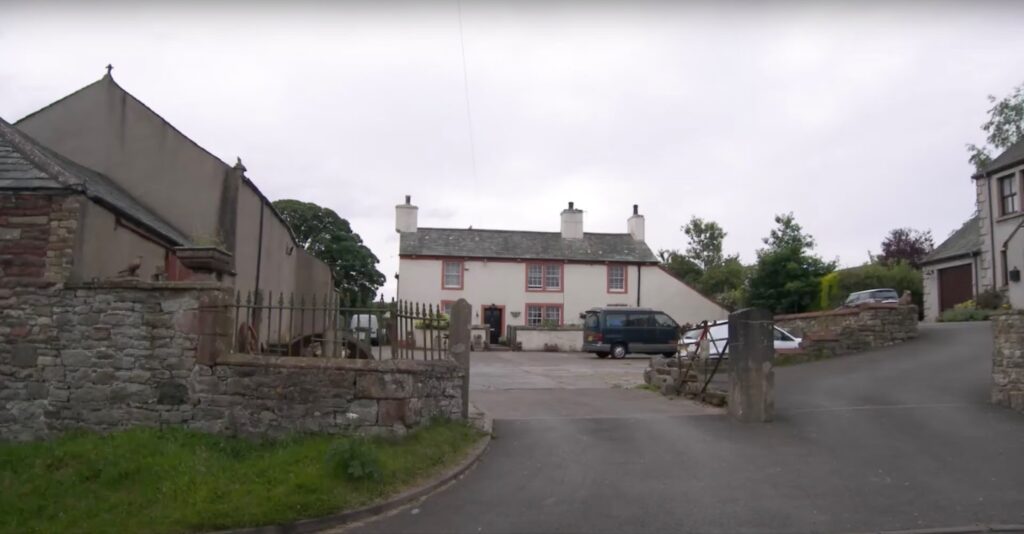 Torpenhow, Cumbria, small buildings with cars parked next to them
